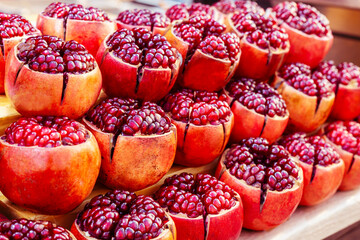 Fresh pomegranates fruits at a market. Celective focus.