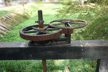 Cogs control the water gates valve to opening and closing for prevent flood