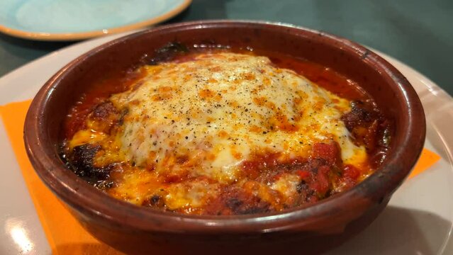 Traditional Italian eggplant parmigiana dish with melted cheese, 4K shot