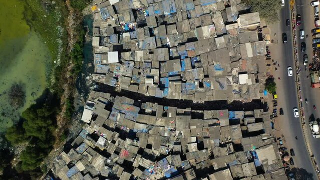 Filthy waterway, in middle of the Dharavi ghetto, in India - Top down drone shot