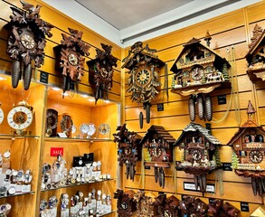 View of a quaint Swiss shop, a picturesque array of traditional cuckoo clocks adorns the walls,...