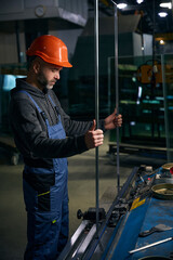 Man in a safety helmet works with a spacer