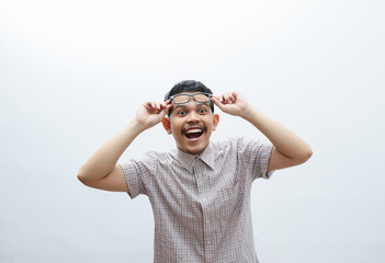 Close-up of happily shocked asian man take-off glasses