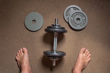 Old used gym weights. Close up on worn dumbbell, fitness equipment in run down gymnasium