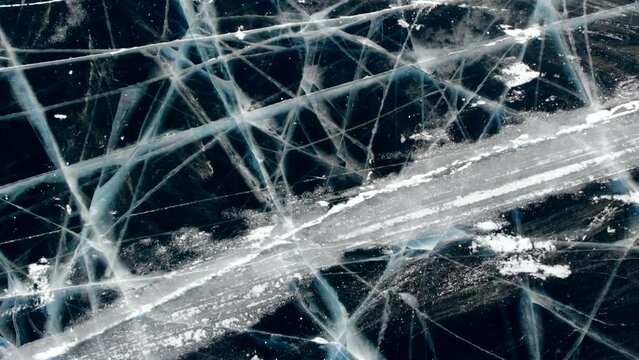 The winter abstract background, representing the golden hue of the frozen Lake Baikal, captures the eye with its unusual beauty and the play of light on the surface of the ice.