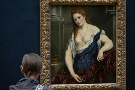 Paris, France, 9 November 2024 : Classic Painting of a Red-Haired Woman in Blue Dress.