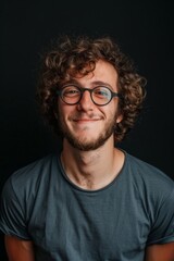 Obraz premium Smiling Man With Curly Hair and Glasses