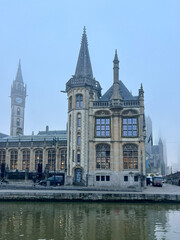 Fototapeta na wymiar Ghent, Belgium. Old historic building near the river Leie on a foggy autumn day.