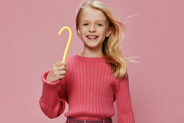 Happy Girl with Pink Lollypop Smile, Style, and Joy This studio portrait captures the childhood innocence and excitement of a young schoolgirl With a beautiful pink lollypop in her hand, she exudes