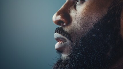 side view profile portrait of  a black man with a long full beard on a studio background - obrazy, fototapety, plakaty