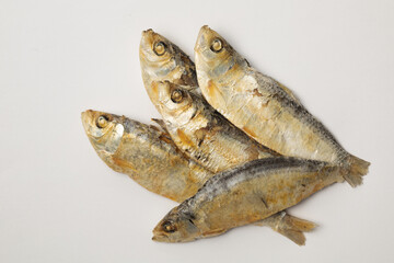 Close up of dried herrings isolated against a white background.