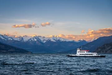 Ferry on Lake Como, Italy with snow covered mountains in the background