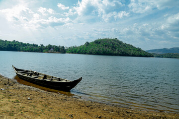 A panoramic view of mountain ranges and canoe  in Amboori, Neyyar Dam