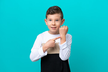 Little kid boy isolated on blue background making the gesture of being late