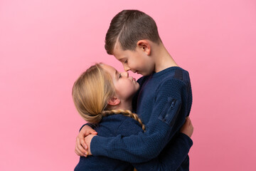 Cute brothers over isolated pink background