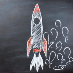 Chalk drawing of a rocket on blackboard