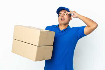 Delivery Ecuadorian man isolated on white background doing surprise gesture while looking to the side