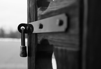 The lock hanging on an ancient wooden door