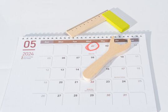05 page of 2024 calendar. The month of May 2024 with 1st May marked with red for labour day. Wooden tools and red circle 1st May illustrating world labor day. The calendar with white background. 