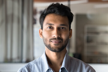 Positive handsome young Indian man head shot front portrait. Successful entrepreneur, startup...