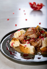 Braised turkey with pomegranate seeds and toasted baguette
