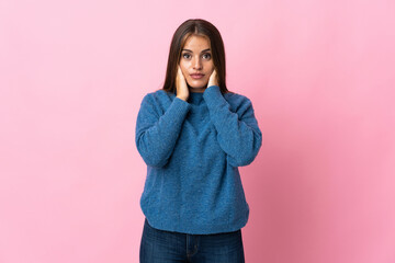 Young Uruguayan woman isolated on pink background frustrated and covering ears