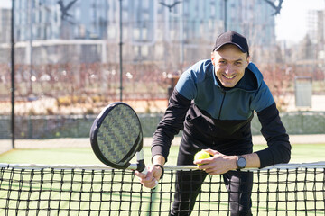 paddle player resting against the wall entertained by the ball