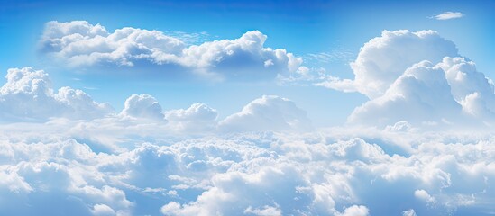 An airplane gracefully gliding high up in the sky amidst billowy volumetric cumulus clouds against a serene blue background - obrazy, fototapety, plakaty