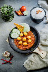 Hot plate egg or Sambal Gami Telur is Traditional food from Indonesia. Served on plate with a bowl of rice and vegetables top view. Super hot and spicy food