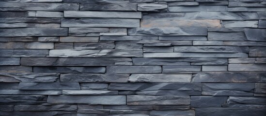 Detailed close-up showcasing the texture of a slate wall against a deep black background, perfect for design projects