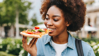 Person Holding Slice of Pizza