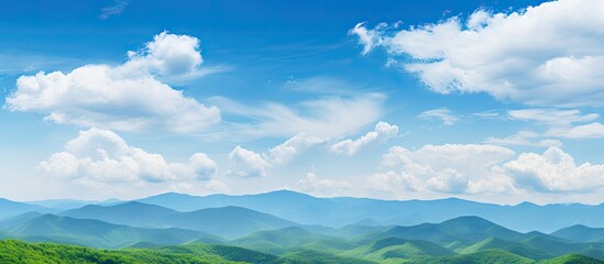 Scenic landscape featuring a distant mountain range and cloudy sky, perfect for World Environment Day concept with green mountains and blue sky - Powered by Adobe