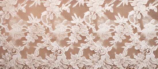 Detailed close-up of white lace fabric featuring intricate floral and leaf designs in a studio setting