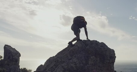 Cliff, sky and happy man celebration of mountain climbing success, destination goal or hiking achievement. Winner, arms raised and athlete excited for trekking, nature freedom or backpacking victory