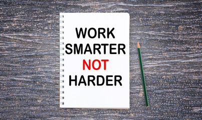Business quotes, WORK SMARTER NOT HARDER on notebook or paper in office desk, office workplace,