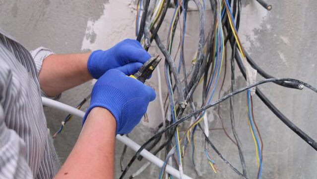 Electrical engineer preparing wiring cable isolation for circuit panel inside a house