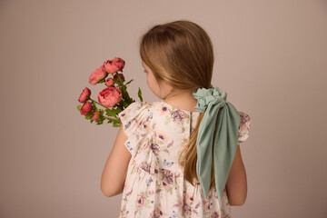 Little girl holding a bouquet of flowers 