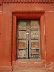 A weathered wooden door displaying the marks of time and showcasing its vintage appeal.