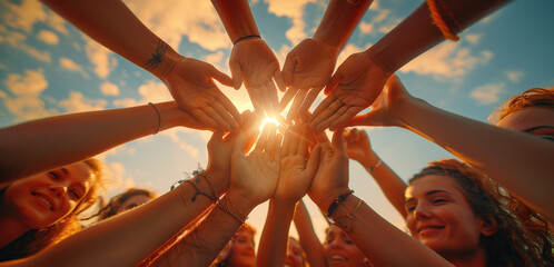 Close-up, camera looking up from below, group of people joining hands together, cheering and getting ready to take the field as the sun rises. Generative AI.