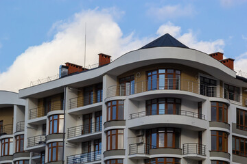 Fototapeta na wymiar Architectural details of modern high apartment building facade with many windows and balconies