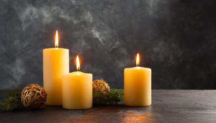 Fototapeta na wymiar Burning candles on dark background. front view.