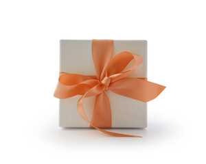 White gift box with orange ribbon bow isolated on white background