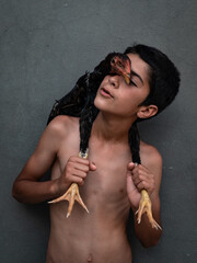 Middle eastern boy playing with rooster