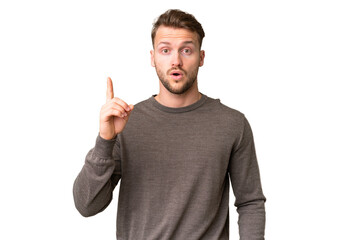 Young handsome caucasian man over isolated chroma key background intending to realizes the solution...