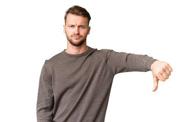 Young handsome caucasian man over isolated chroma key background showing thumb down with negative...