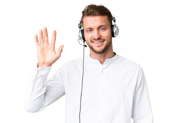 Telemarketer caucasian man working with a headset over isolated chroma key background saluting with...