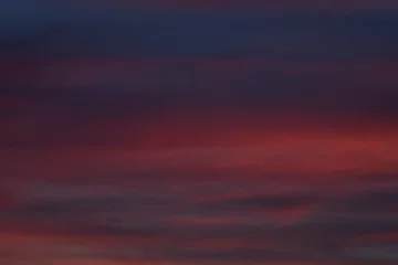Rolgordijnen Dramatic sunset with vibrant clouds lit by a sun © GCapture