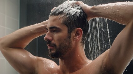 Guy in the shower washes his hair