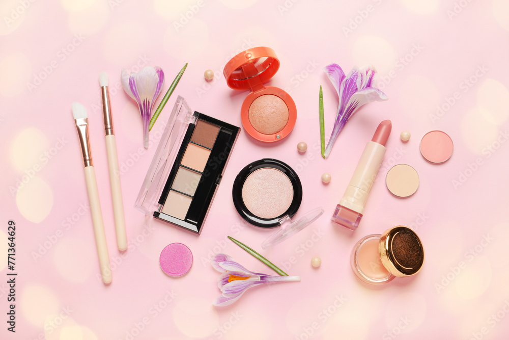 Wall mural Different makeup products and beautiful crocus flowers on pink background, flat lay. Bokeh effect