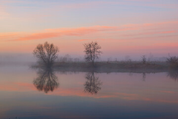 Fototapeta na wymiar misty sunrise over the lake